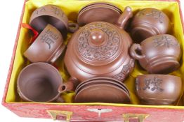 A Chinese Yixing earthenware tea set comprising tea pot, and six cups and saucers