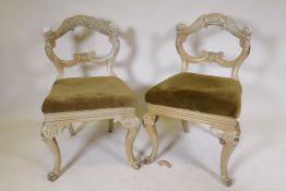 A pair of Anglo Indian painted side chairs, with carved shaped backs, raised on cabriole supports