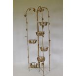 A vintage French gold painted metal folding jardiniere stand with grape and vine decoration, 160cm