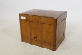 A Victorian amboyna tantalus, with bird's eye maple cross banding and borders, the lift up top and