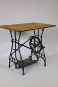 A Victorian cast iron sewing machine stand, fitted with a pine top, 79 x 58 x 74cm