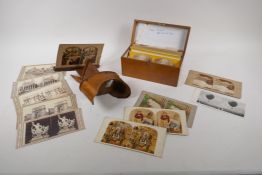 An early C20th stereoscopic viewer, and a boxed collection of viewer cards depicting various