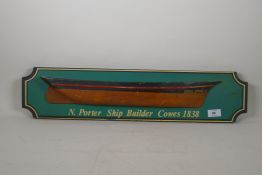 A decorative late C20th painted wood half hull model of a sailing ship, 67cm long