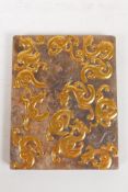 A Chinese carved hardstone tablet with kylin decoration overlaid with gilt metal, 10cm x 12cm