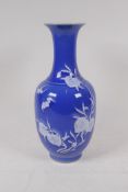 A blue glazed porcelain vase with raised white enamel peach tree decoration, Chinese Qianlong seal