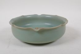 A Chinese celadon glazed pottery dish with lobed rim and character inscription, 19cm diameter