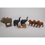 A collection of Indian carved wood animals including a pair of ebony elephants, cows etc, largest