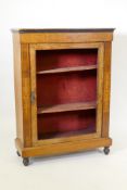 A Victorian inlaid and ebonised walnut pier cabinet with single door, lacks glass, raised on