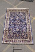 A rich blue ground full pile Kashmir carpet with an all over floral design, 240cm x 160cm