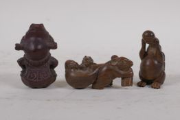 A carved wood netsuke of a rat drinking from a gourd, another of a toad and another of a rat pulling