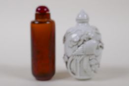 A Chinese gold flake amber glass snuff bottle and a blanc de chine porcelain snuff bottle, 8cm high