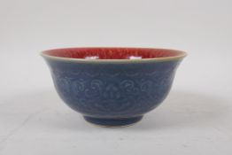 A Chinese porcelain rice bowl with copper flambe glazed interior, and a blue glazed exterior over
