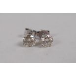 A pair of 14ct white gold and diamond stud earrings, approx 86 points