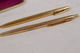 A gilt cased Parker ballpoint pen and bark finish gilt cased Sheaffer ballpoint pen