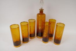 A German amber glass decanter and six tumblers with gilt decoration of a crown and 'W' coat of arms,