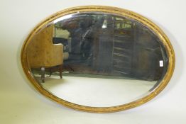 A Victorian giltwood oval wall mirror with bevelled glass, 117 x 82 cm