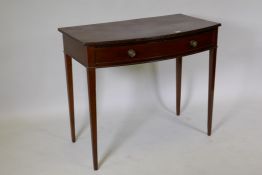 A George III mahogany bow front single drawer side table, the top with reeded edge and oak lined