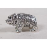 A miniature silver bear figure with blue stone set eyes, 3cm long