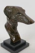 A stylised head bust of a greyhound mounted on a stepped marble base, 23cm high