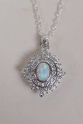 A 925 silver pendant necklace set with an oval opalite panel encircled by cubic zirconia, 2.5cm drop