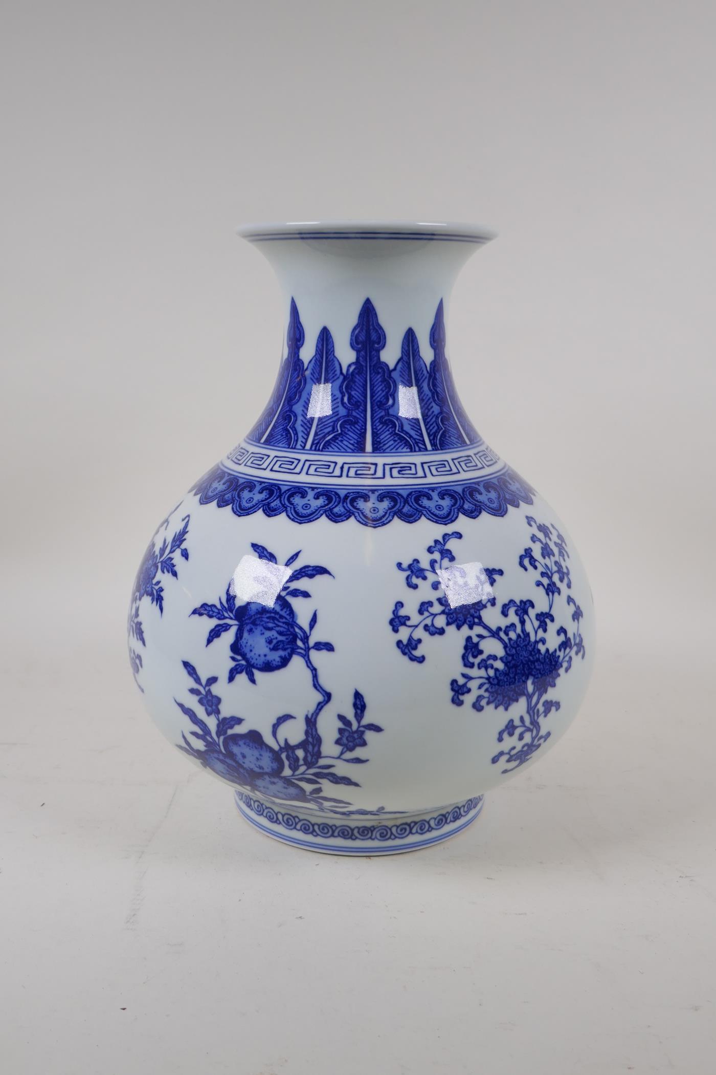 A blue and white porcelain vase decorated with flowers and fruiting peach and pomegranate trees, - Image 4 of 6