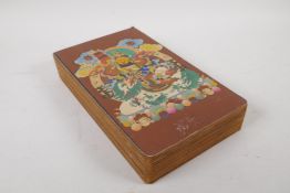 A Sino Tibetan printed concertina book depicting various thangkas, 17cm x 28cm