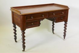 A Victorian mahogany four drawer kneehole desk, with three quarter gallery top and moulded front