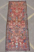 A washed terracotta ground Persian Hamadan runner, with all over floral pattern, 108cm x 284cm