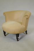 A Victorian tub shaped nursing chair, raised on turned supports