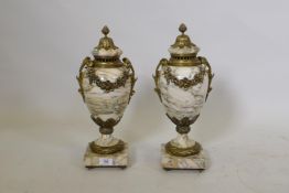 A pair of marble and brass mounted urns and covers, drilled for electricity, one cover chipped, 43cm