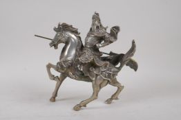 A Chinese white metal figure of the warrior Guan Gong (Guan Yu) on horseback, 19cm high