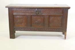 An C18th elm planked coffer with triple panel carved front, 108 x 43 x 60 cm
