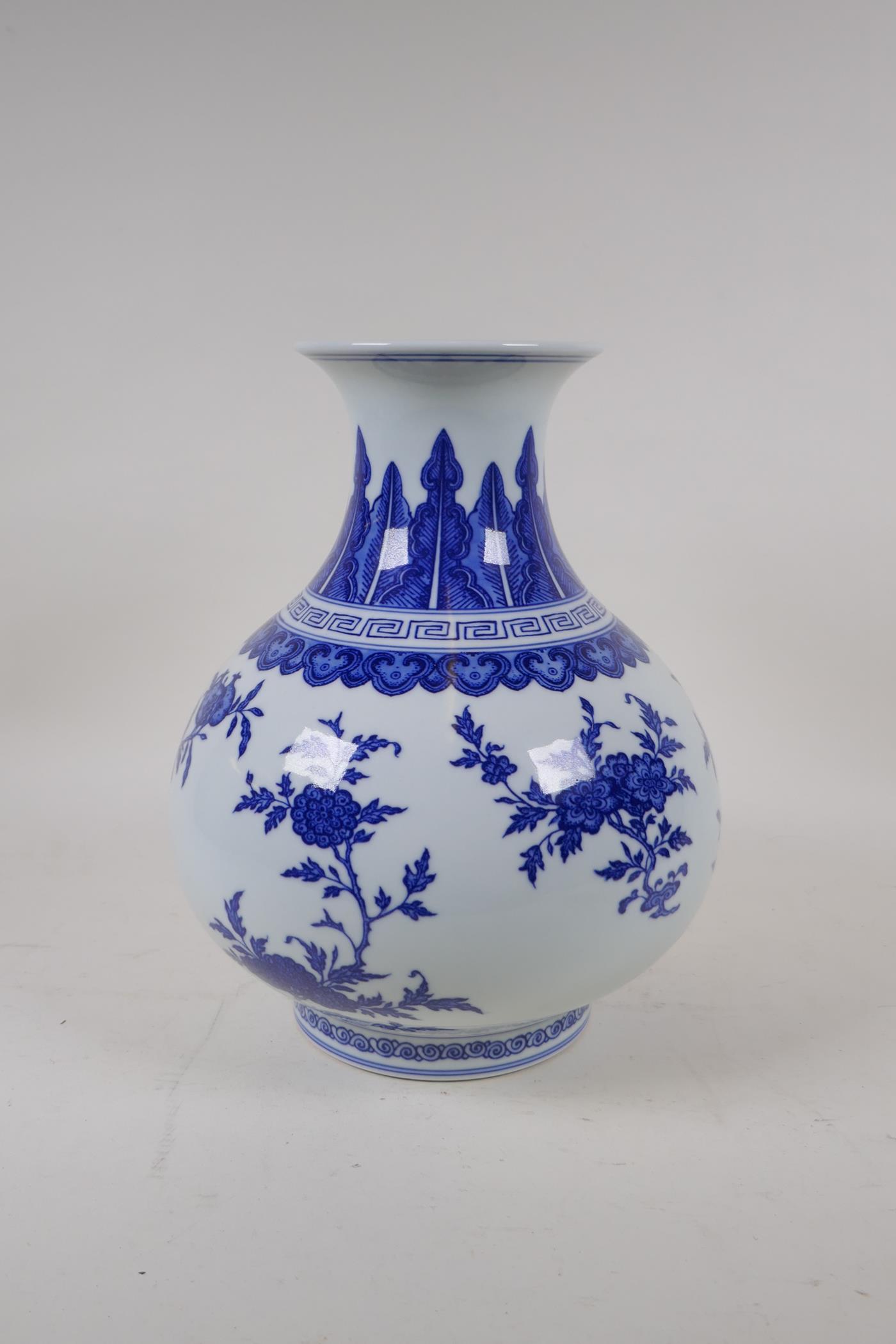 A blue and white porcelain vase decorated with flowers and fruiting peach and pomegranate trees, - Image 3 of 6