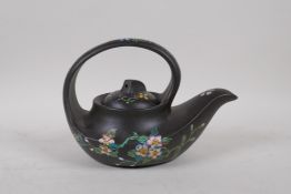 A Chinese earthenware Yixing tea pot with famille rose enamel floral decoration, impressed seal mark