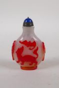 A Peking glass snuff bottle with raised bat, kylin and peach tree decoration, 7cm high