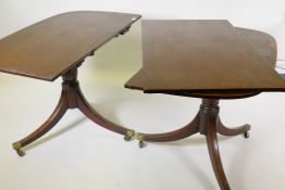 A mahogany twin pedestal dining table with extra leaf, each with snap top, raised on turned
