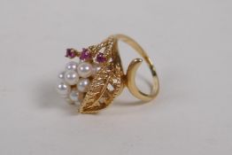 A 14ct yellow gold, ruby and seed pearl ring with a unique cornucopia design, size K/L, unmarked