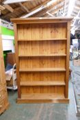 A pine open bookcase on a plinth base, 121 x 31cm, 182cm high