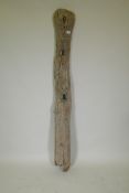 A weathered Ethiopian wooden post with carved face decoration, 170cm high