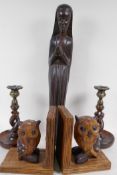 A carved wood figure of a nun, 47cm high, and a pair of barley twist oak candlesticks, and a pair of