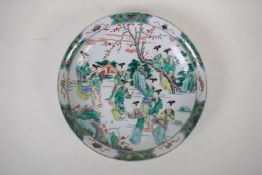 A famille vert porcelain cabinet plate decorated with women in an ornamental garden, Chinese