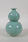 A Chinese celadon glazed porcelain double gourd vase, with incised phoenix decoration, mark to base,
