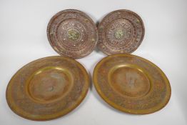 Two Bidri style Indian brass chargers, 40cm diameter, and a pair of embossed copper plaques, 30cm