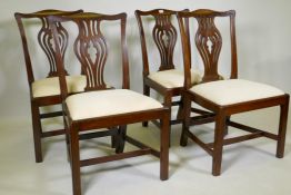 Four C19th mahogany dining chairs with pierced vase splat backs, drop in seats, raised on square