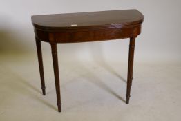 A George III D shaped mahogany card table, with cross banded and reeded edge and inlaid frieze,