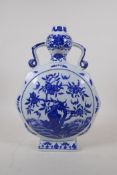 A blue and white porcelain two handled garlic head shaped moon flask decorated with a fruiting peach