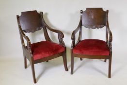 A pair of oak Empire style open arm chairs with carved decoration, late C20th, 92cm high