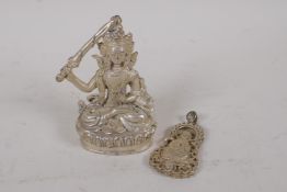 A Chinese white metal figure of a female deity, and a white metal Quan Yin pendant, largest 9cm high