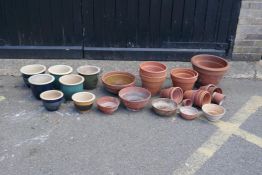 A collection of terracotta and ceramic garden planters, largest 36cm diameter