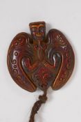 An Oriental moulded pendant in the form of a bat, 6 x 6cm